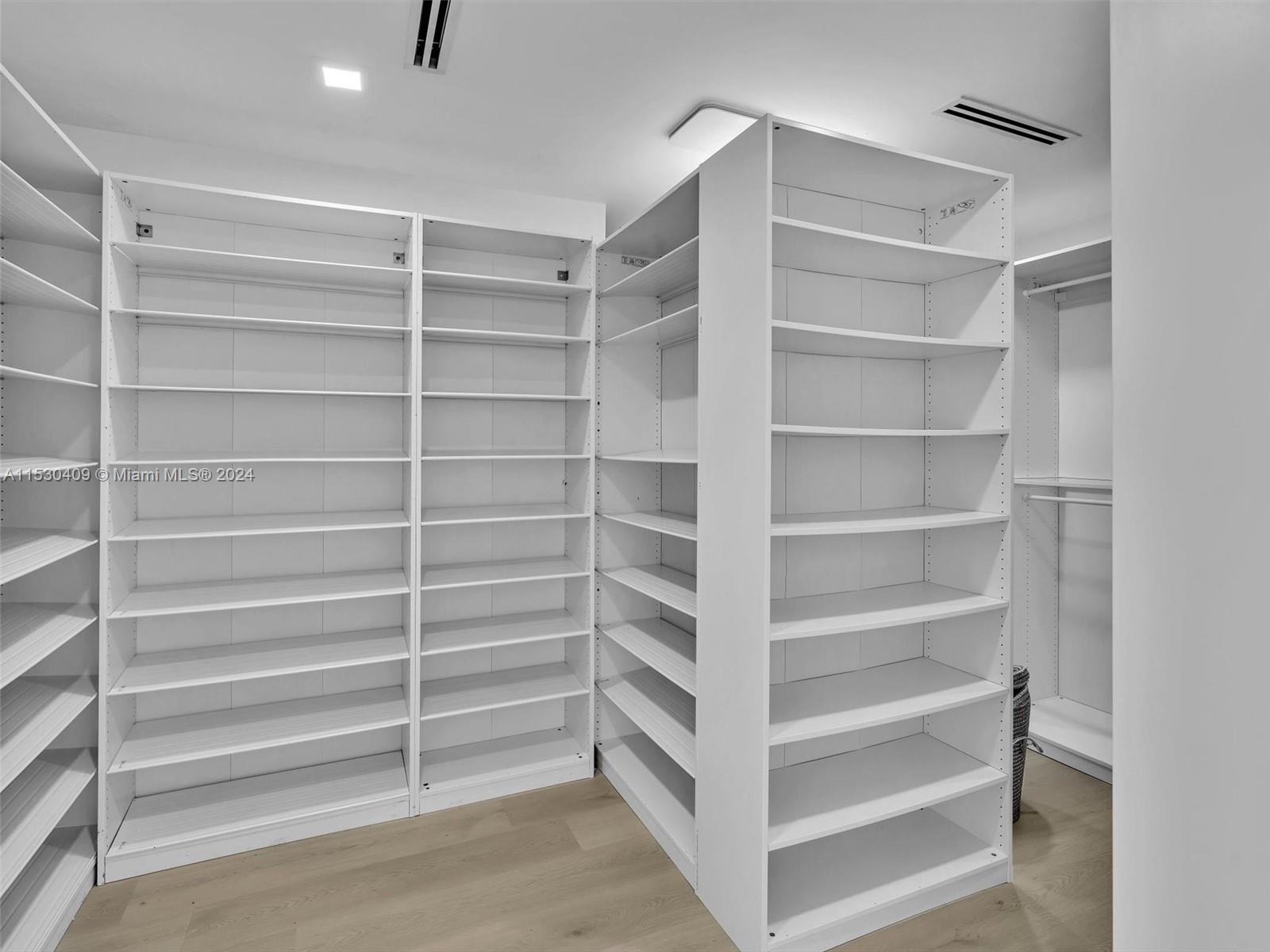 3010 Alton Road Miami Beach, FL 33140 - Photo 28 of 41 a view of walk in closet with empty racks