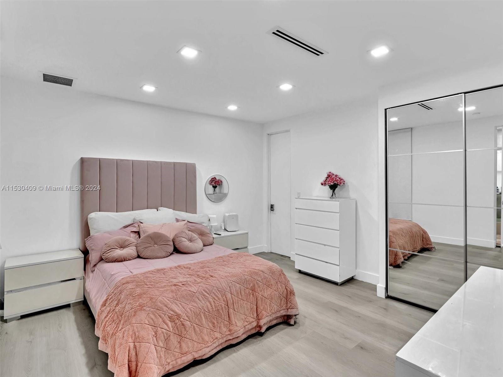 3010 Alton Road Miami Beach, FL 33140 - Photo 30 of 41 a bedroom with a bed and a dresser