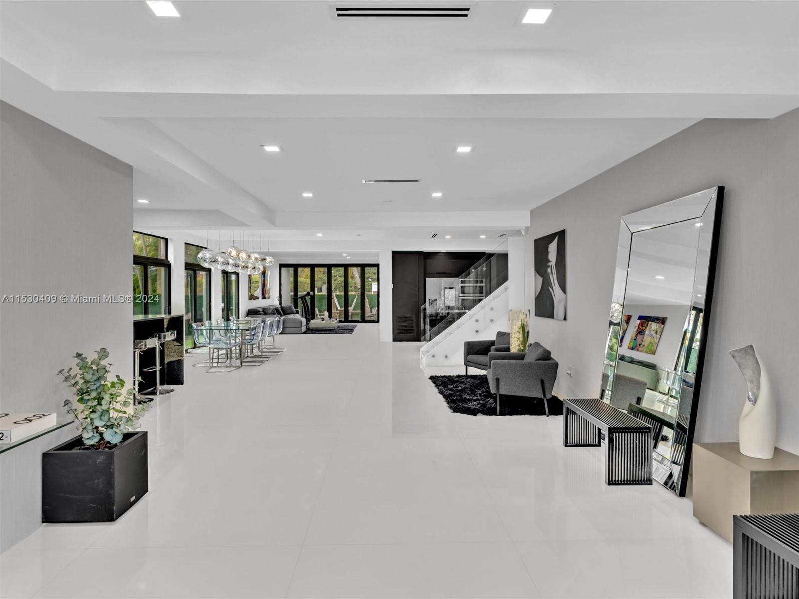 3010 Alton Road Miami Beach, FL 33140 - Photo 3 of 41 a living room with furniture and a chandelier