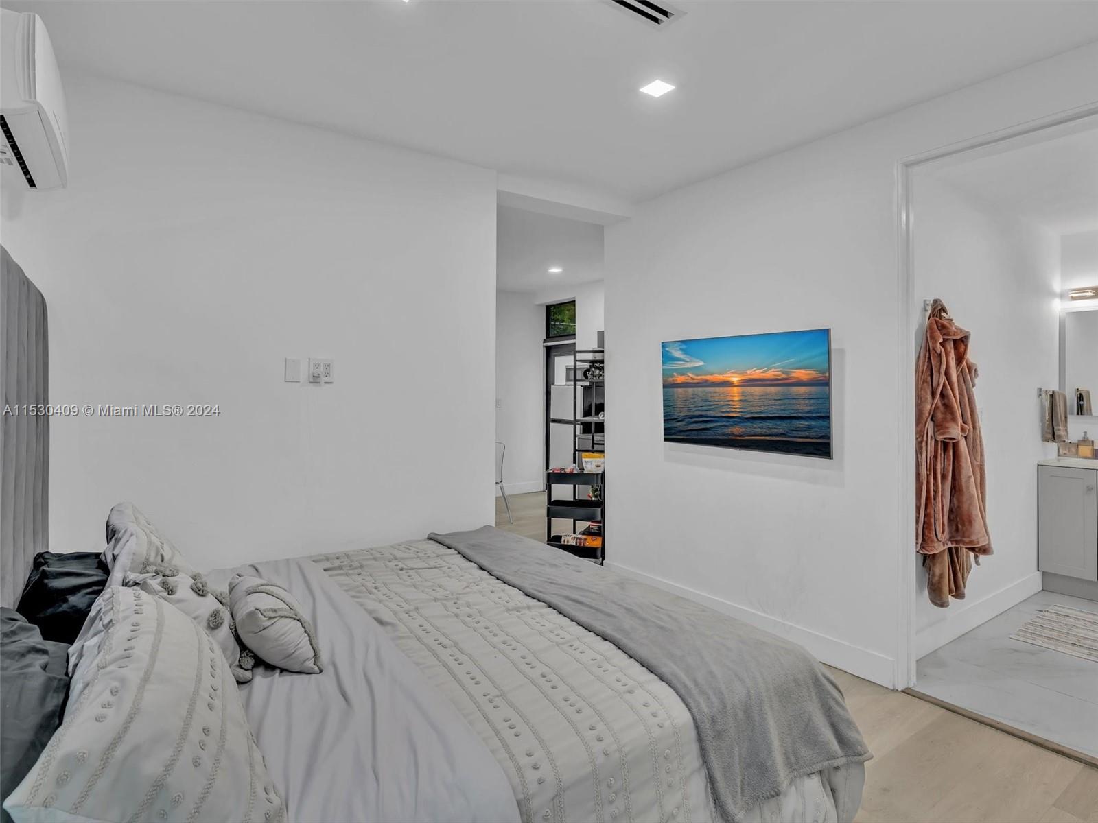 3010 Alton Road Miami Beach, FL 33140 - Photo 31 of 41 a bedroom with a bed and a flat screen tv