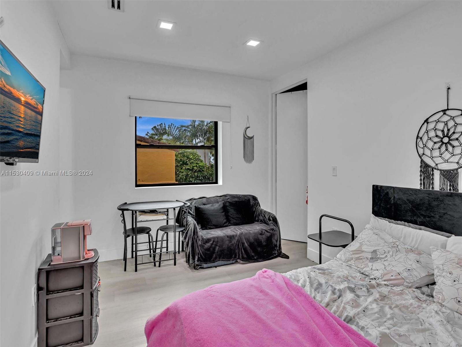 3010 Alton Road Miami Beach, FL 33140 - Photo 34 of 41 a bedroom with furniture and a flat screen tv