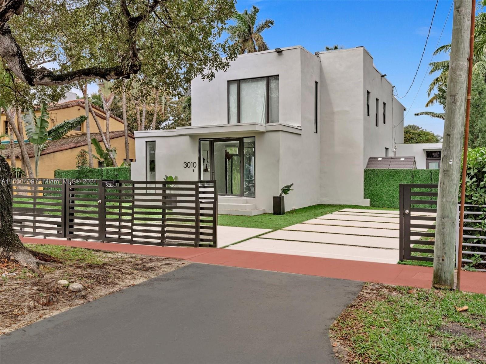 3010 Alton Road Miami Beach, FL 33140 - Photo 4 of 41 a front view of a house with a yard