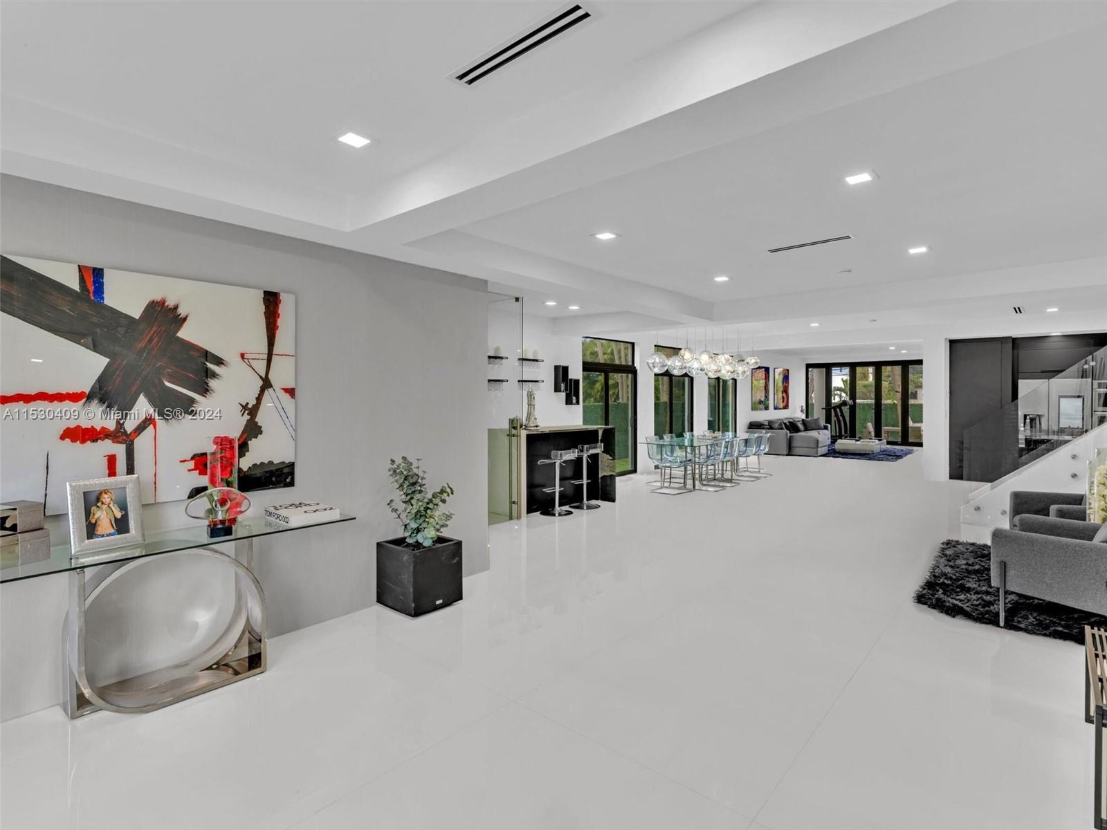 3010 Alton Road Miami Beach, FL 33140 - Photo 6 of 41 a room with gym equipment and a flat screen tv