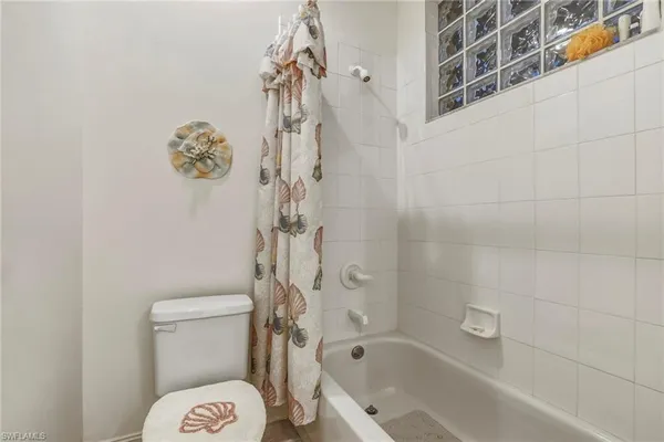 a bathroom with a toilet and shower
