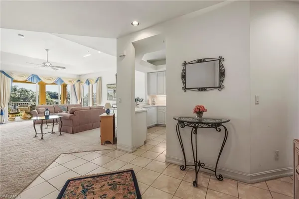 a living room with furniture a flat screen tv and outdoor view