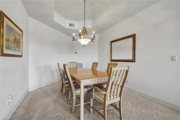 a dining room with furniture and chandelier