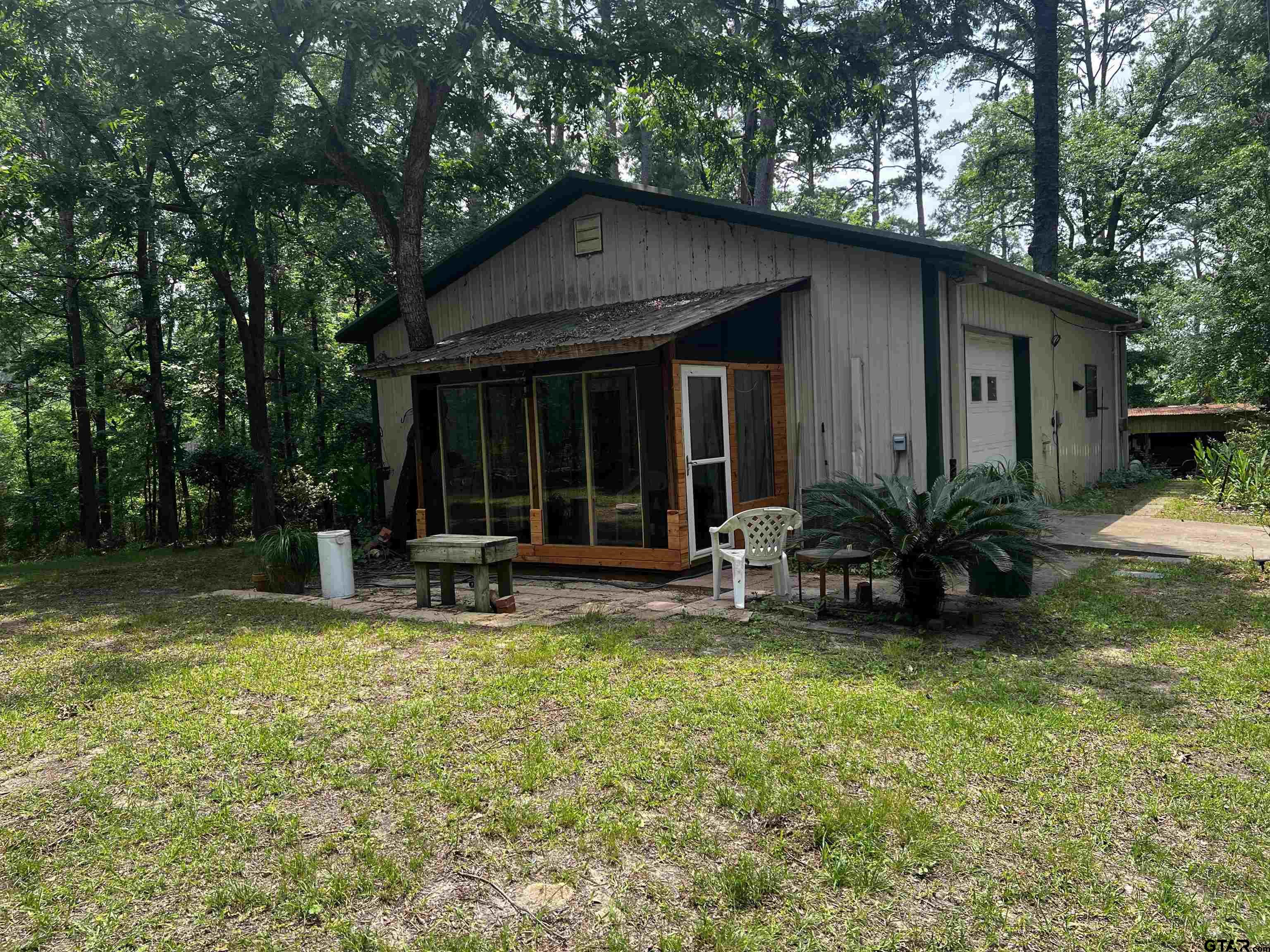 a view of a house with backyard porch and sitting area
