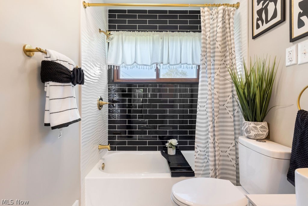 9620 David Road Garfield Heights, OH 44125 - Photo 16 of 36 Bathroom with shower / tub combo and toilet