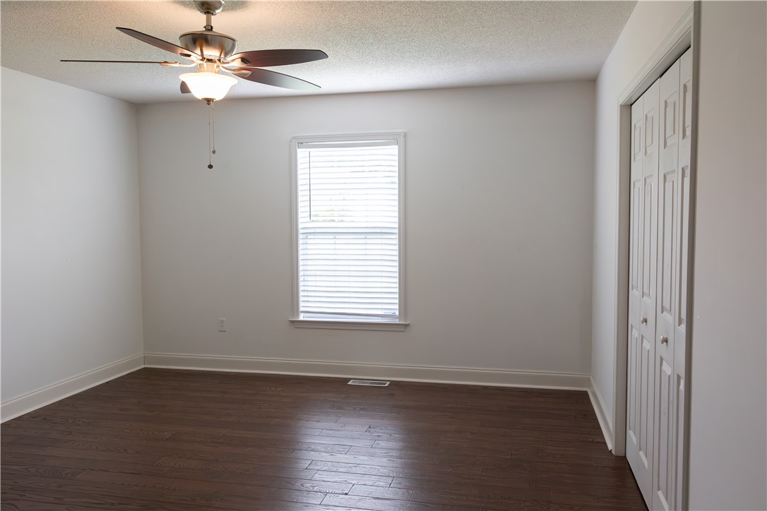 439 Chetola Road Seneca, SC 29672 - Photo 10 of 28 Rich wood-inspired floors and a classic window define this serene bedroom space.