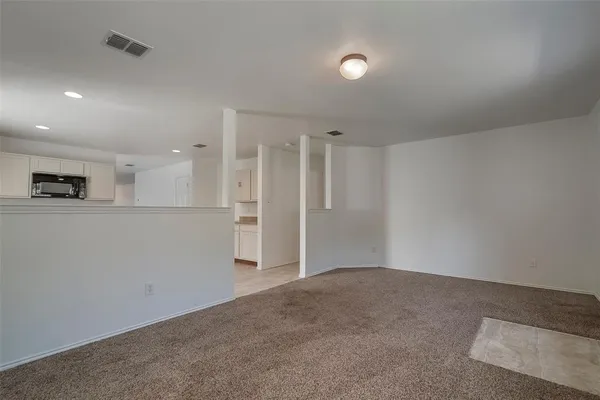 wooden floor in an empty room and a kitchen