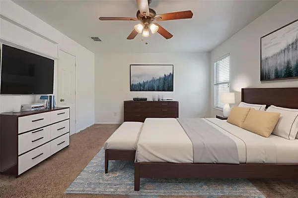 a bedroom with a bed and a flat screen tv