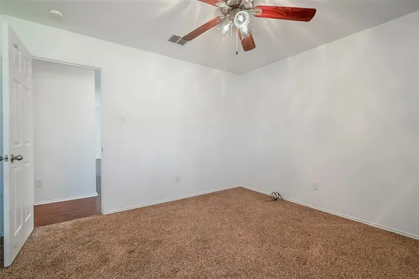 a view of a big room with a ceiling fan