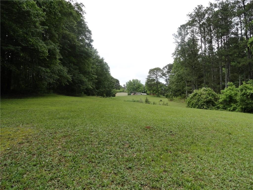 8664 Cumming Highway Canton, GA 30115 - Photo 13 of 18 a view of a field with a trees