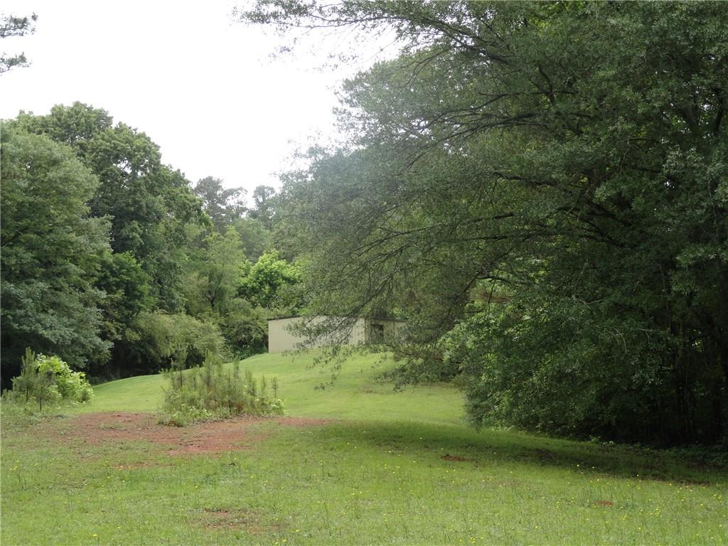 8664 Cumming Highway Canton, GA 30115 - Photo 16 of 18 a view of a garden with a lake