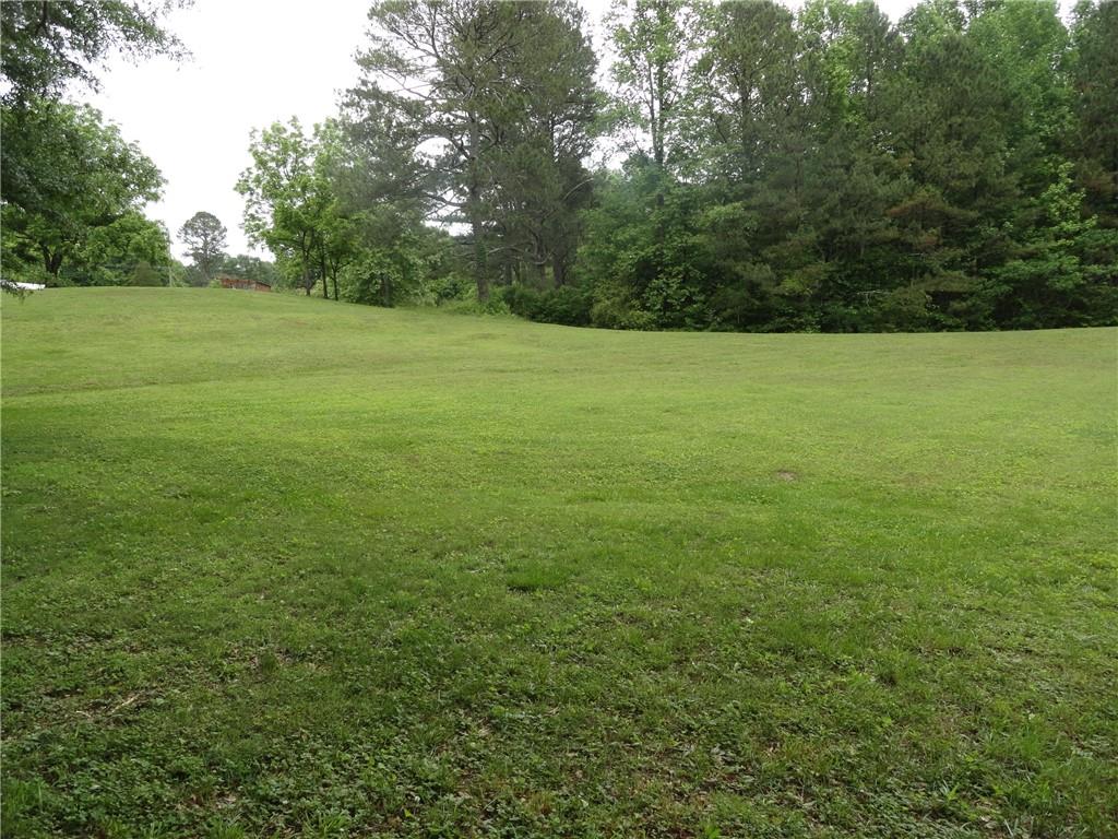 8664 Cumming Highway Canton, GA 30115 - Photo 10 of 18 a view of a field with trees in the background