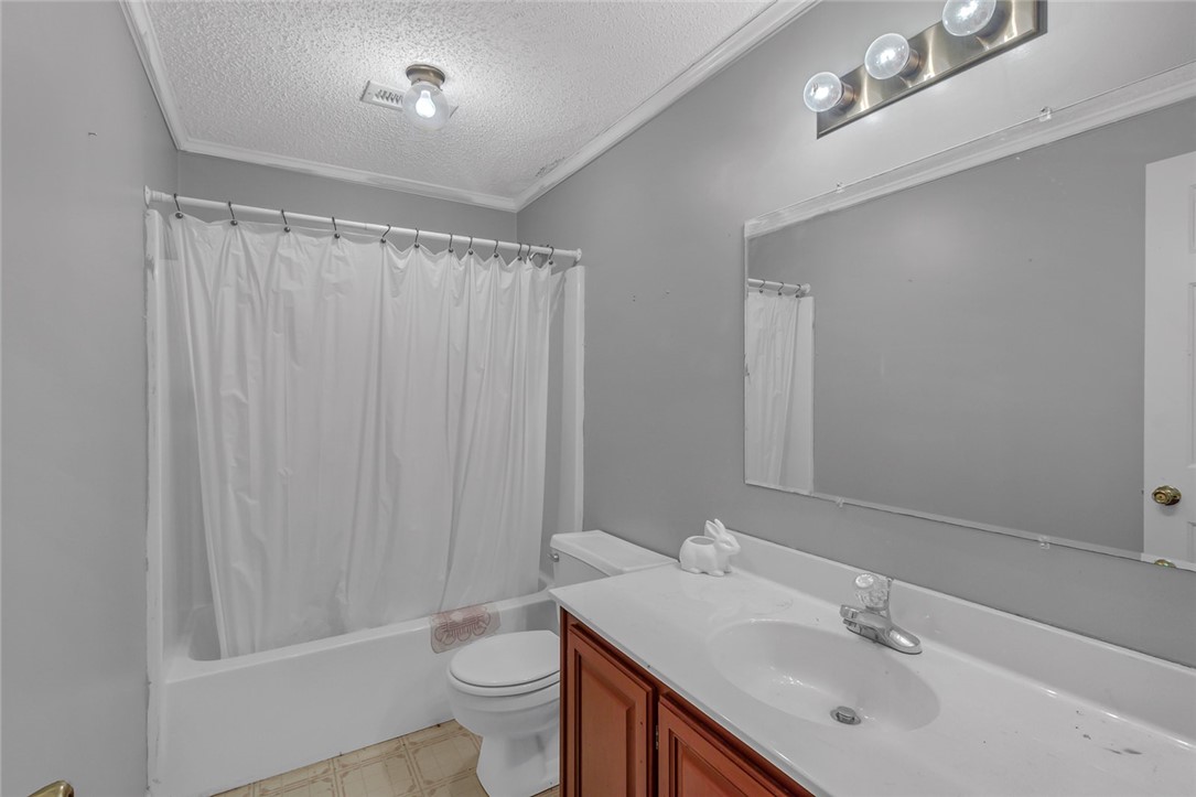 148 Denver Road Heathsville, VA 22473 - Photo 39 of 50 Full bath featuring a textured ceiling, ornamental molding, shower / bath combination with curtain, and vanity
