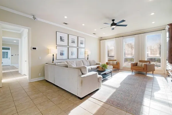 a spacious bedroom with a bed and a chandelier