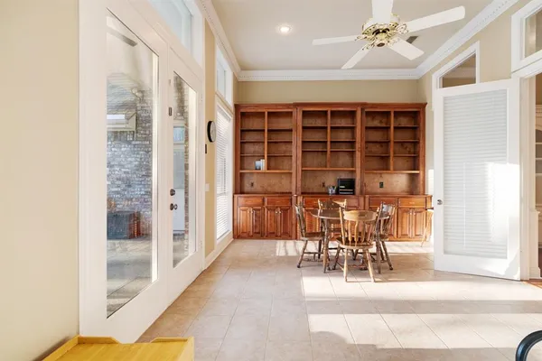 a living room with furniture and floor to ceiling windows
