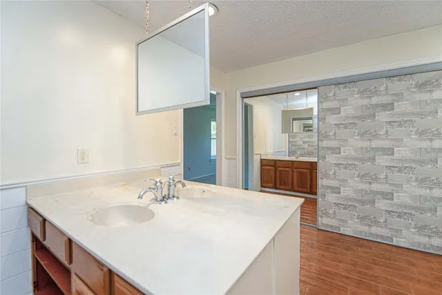 a bathroom with a sink a vanity and a mirror