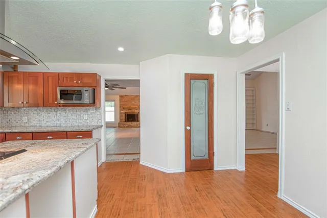 a kitchen with stainless steel appliances granite countertop a refrigerator and a stove top oven