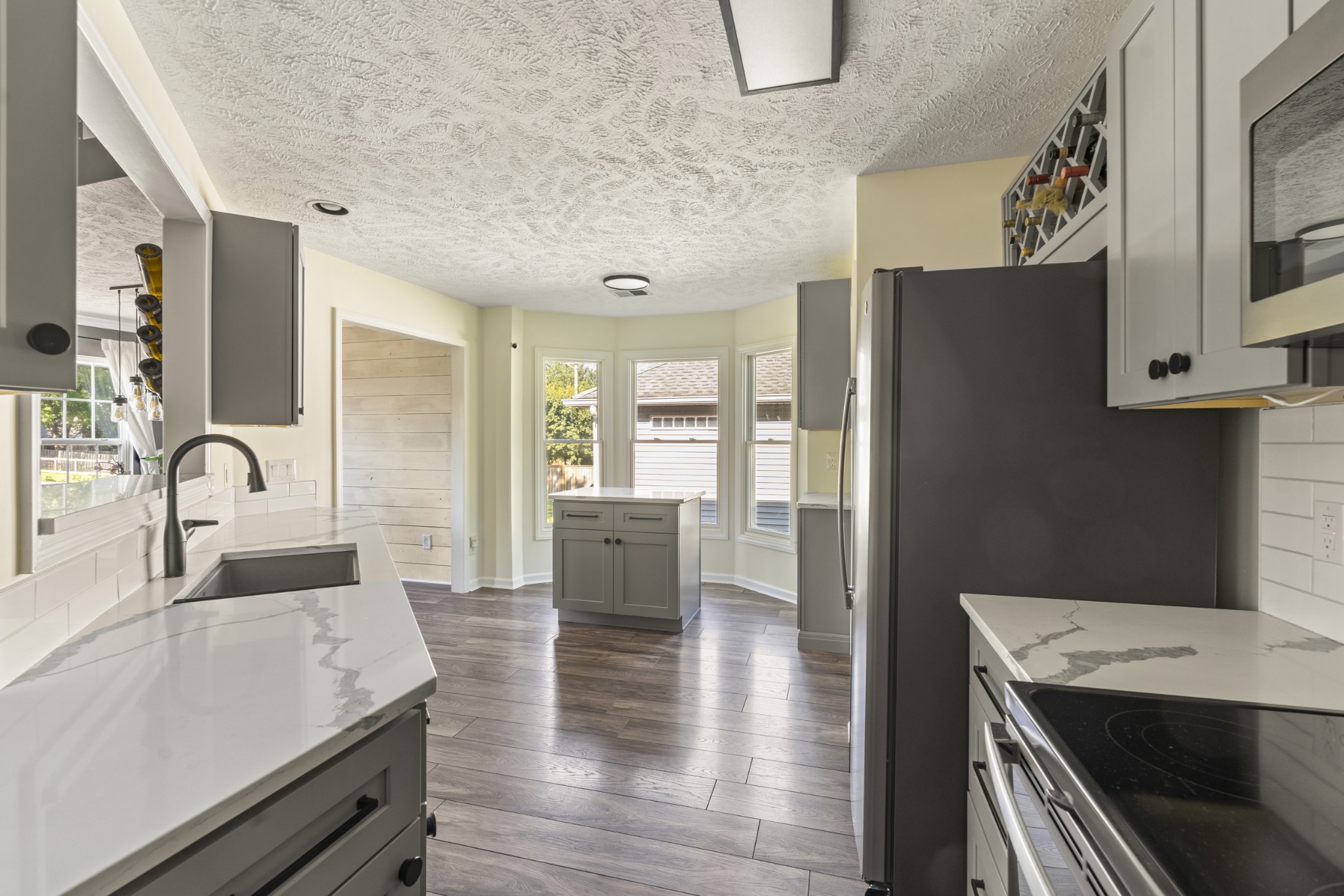 350 Astor Way Franklin, TN 37064 - Photo 14 of 33 a open kitchen with stainless steel appliances granite countertop a lot of counter space and wooden floors