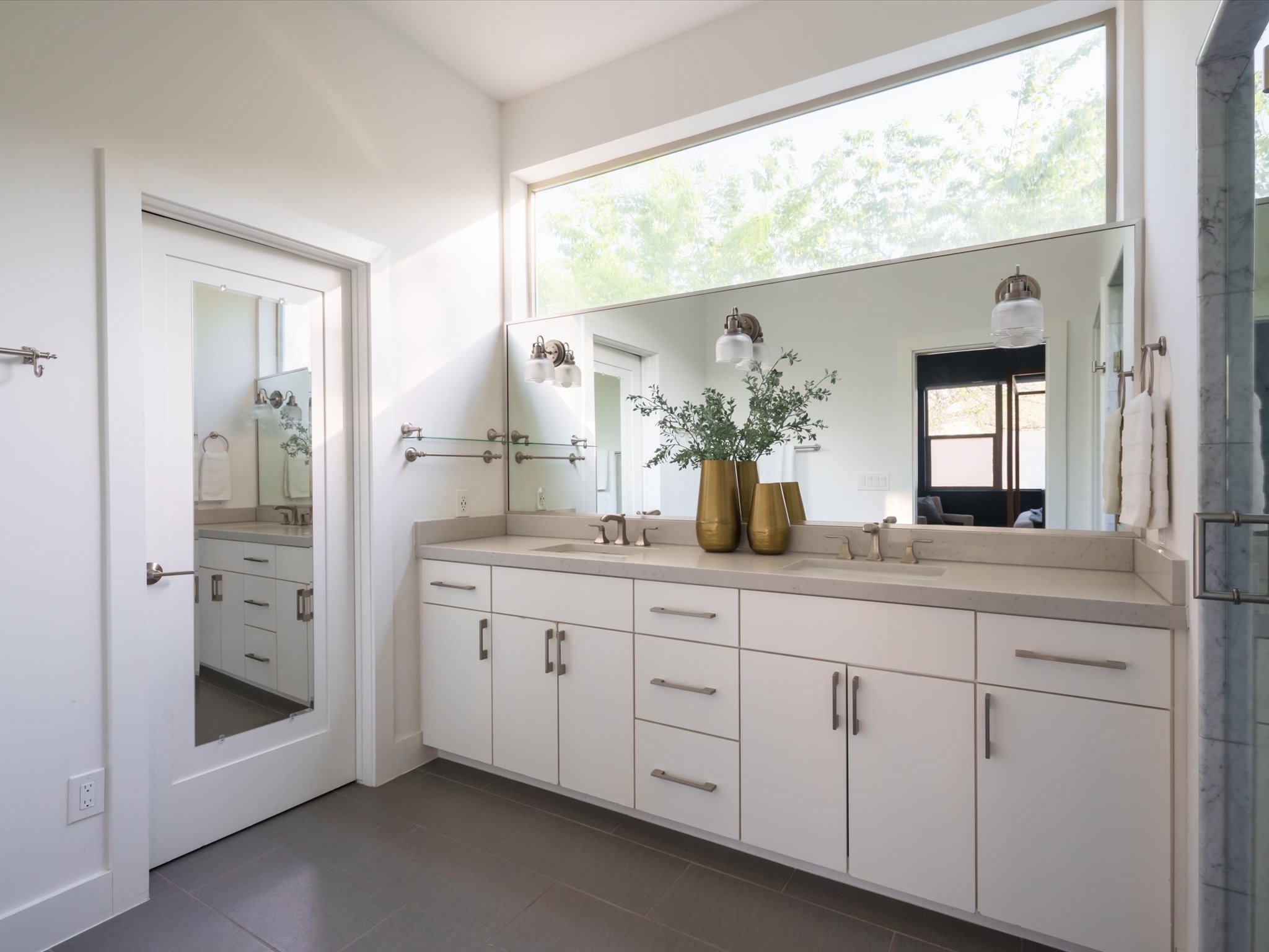 615 Jewell Street Austin, TX 78704 - Photo 15 of 25 Spacious dual vanity with custom cabinetry and a clerestory window above for natural light and a treetop backdrop.