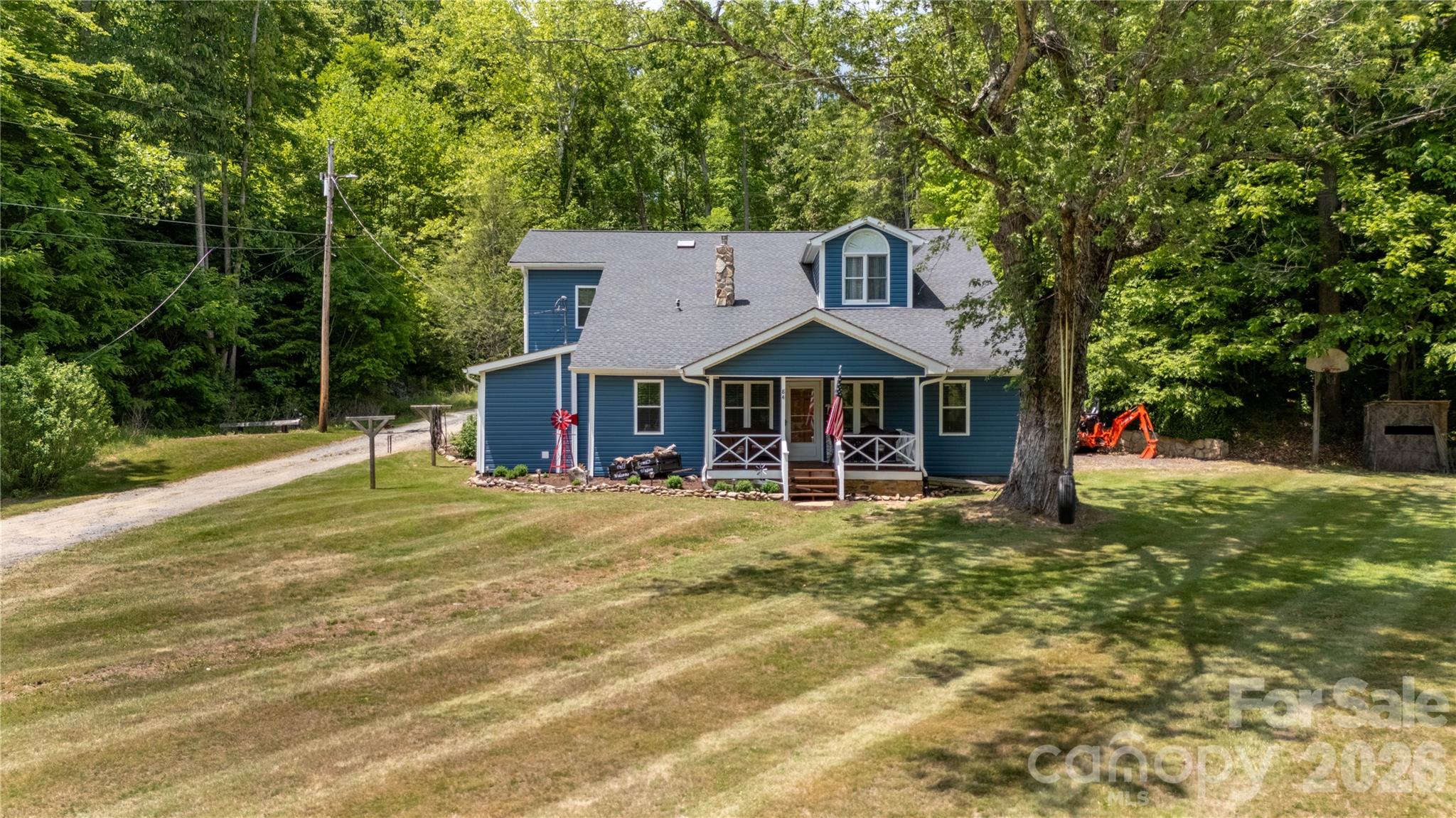 84 Sheets Farm Road Bakersville, NC 28705 - Photo 3 of 42 a front view of a house with a yard