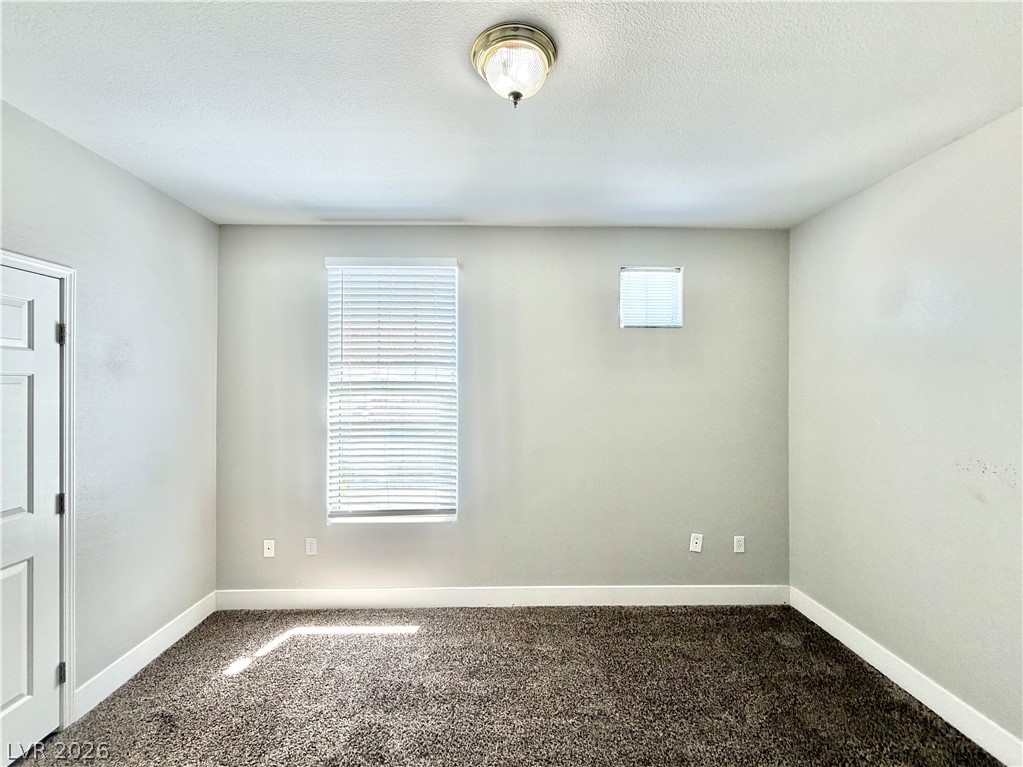 8555 West Russell Road, Unit 2018 Las Vegas, NV 89113 - Photo 20 of 23 A well-lit room offering plush carpeting and functional window blinds, ready for personalization.
