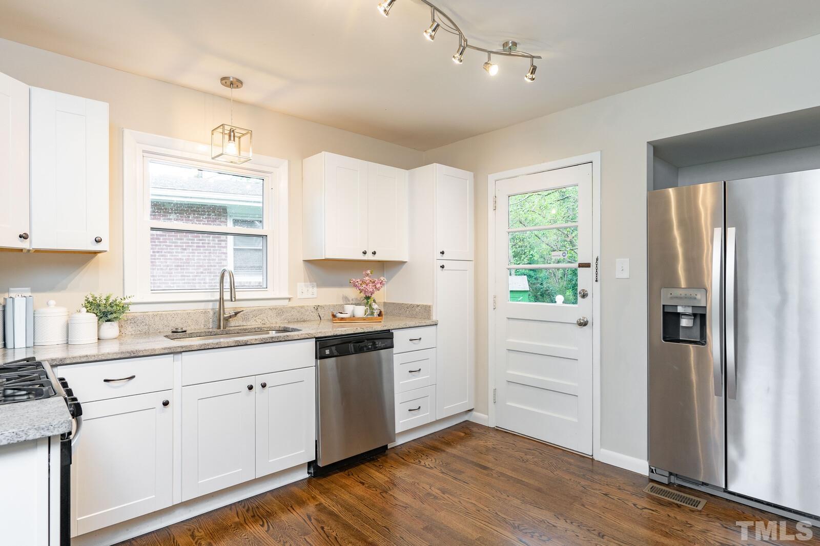 904 Friar Tuck Road Raleigh, NC 27610 - Photo 3 of 13 a kitchen with a sink stove and refrigerator