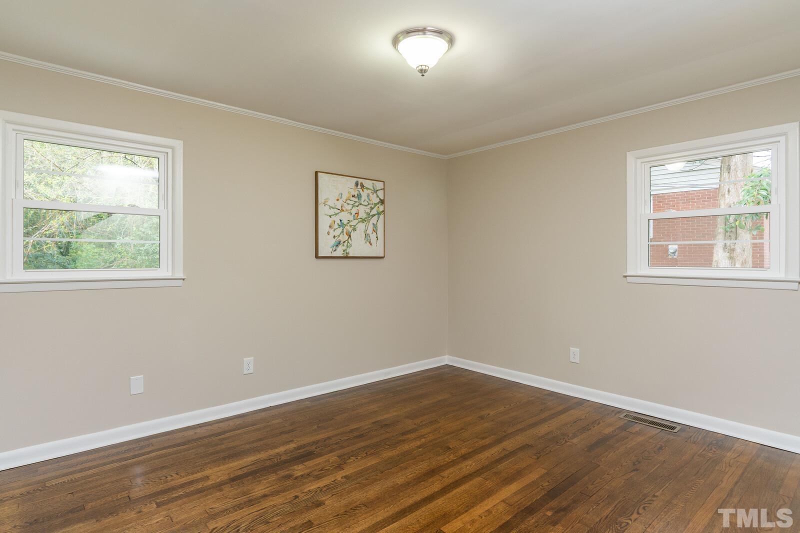 904 Friar Tuck Road Raleigh, NC 27610 - Photo 9 of 13 a view of a room with wooden floor and window