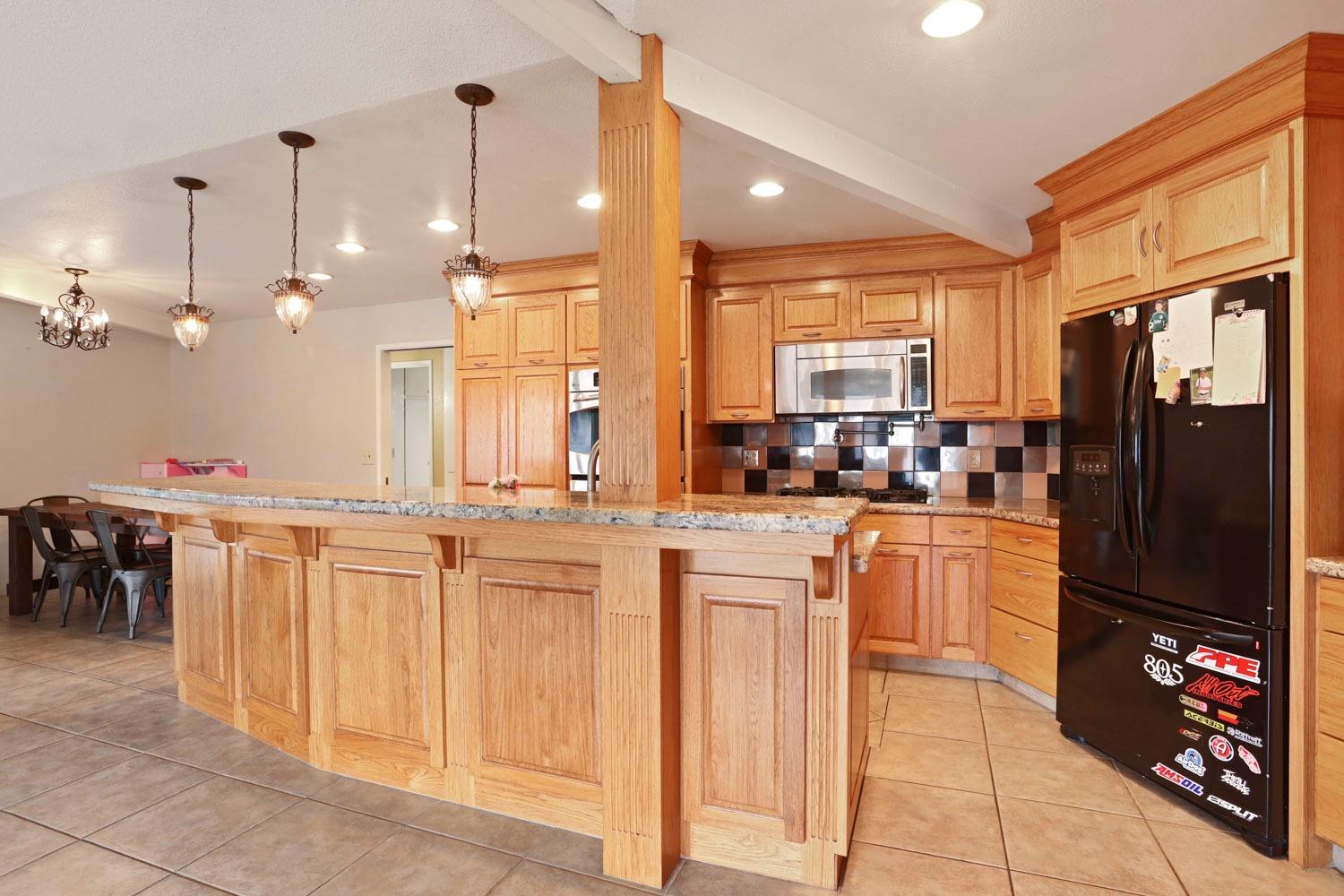 1631 North Johnson Road Turlock, CA 95382 - Photo 12 of 38 a kitchen with stainless steel appliances granite countertop a refrigerator and a sink