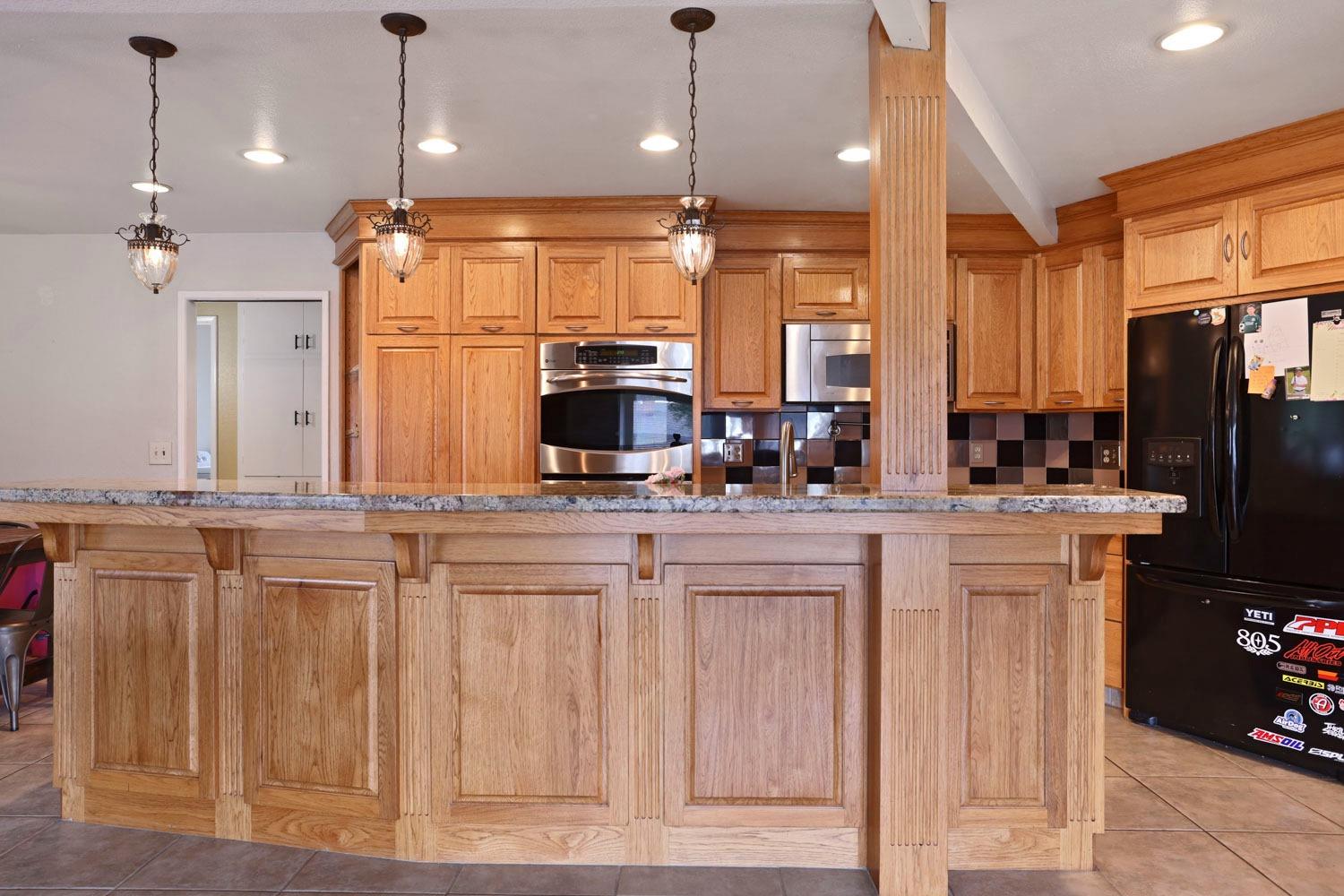 1631 North Johnson Road Turlock, CA 95382 - Photo 16 of 38 a kitchen with stainless steel appliances granite countertop a refrigerator a sink and a stove