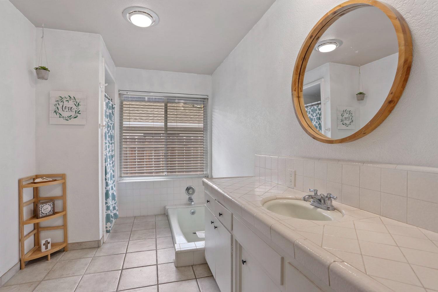 1631 North Johnson Road Turlock, CA 95382 - Photo 23 of 38 a bathroom with a sink and a mirror