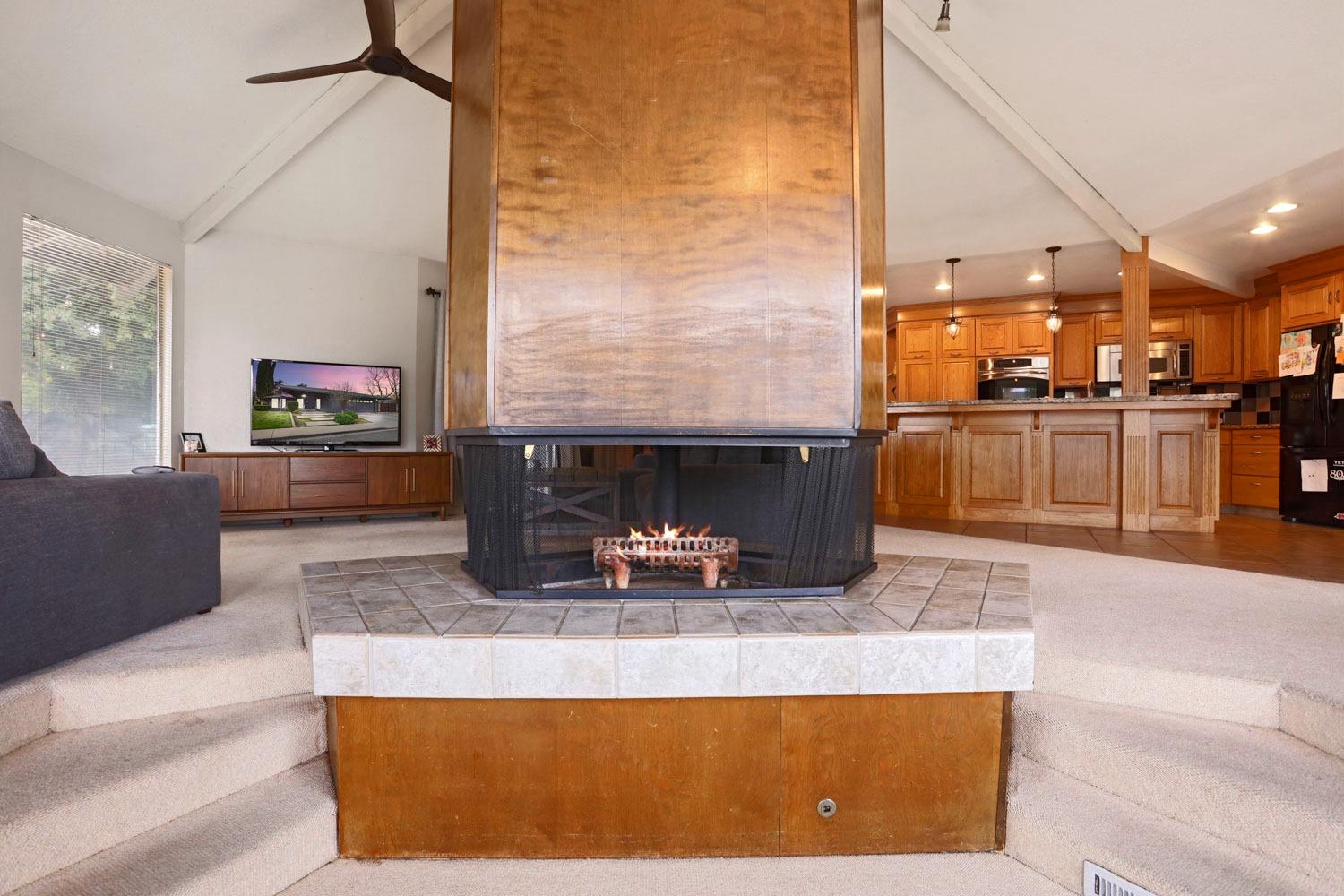1631 North Johnson Road Turlock, CA 95382 - Photo 8 of 38 a kitchen with kitchen island granite countertop a refrigerator dining table and chairs