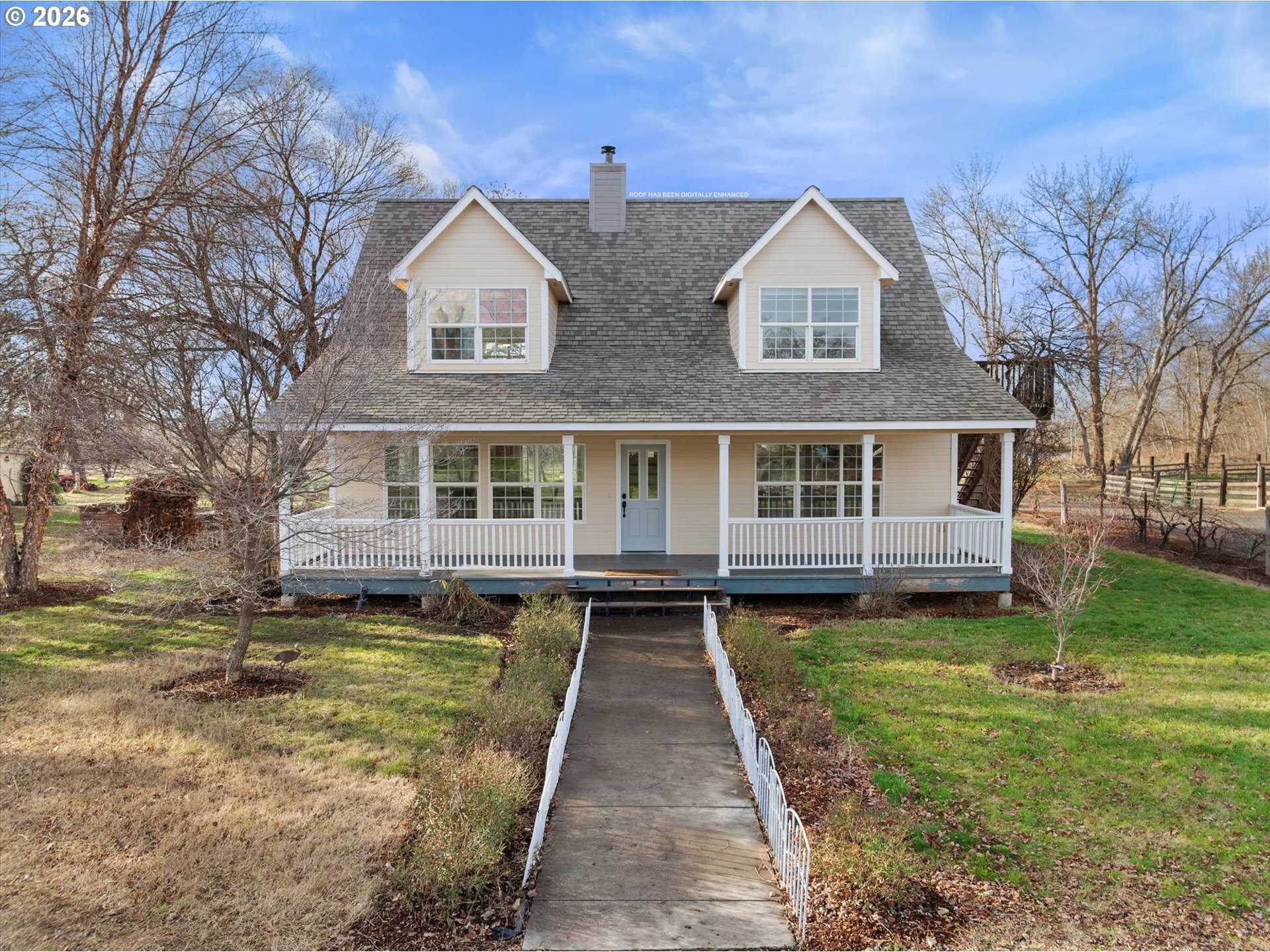 a front view of a house with a garden and lake view