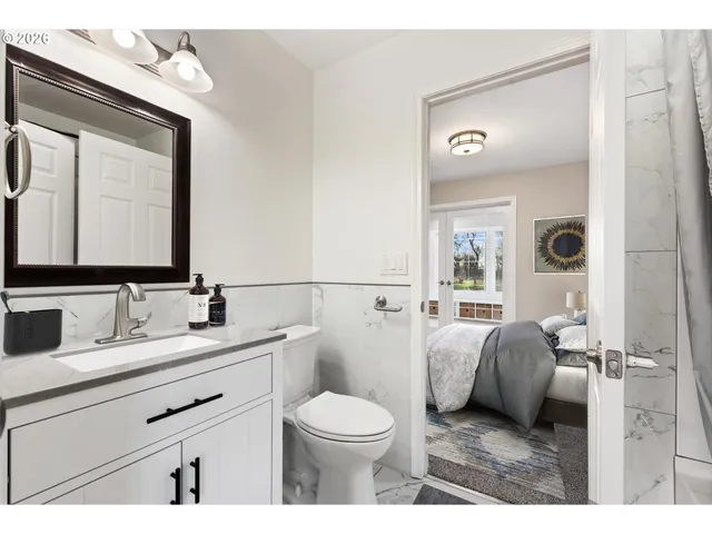 a bathroom with a toilet a sink and a mirror