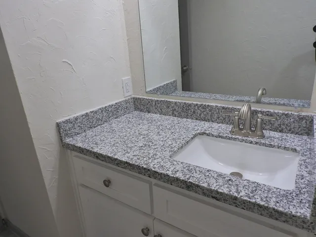 a bathroom with sink and mirror