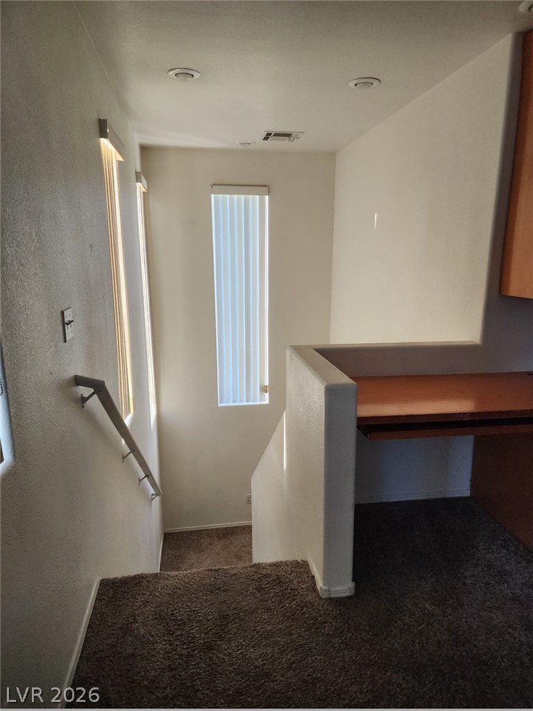 11901 Fairfax Ridge Street Las Vegas, NV 89183 - Photo 17 of 46 Staircase with carpet flooring, a textured wall, and built in desk