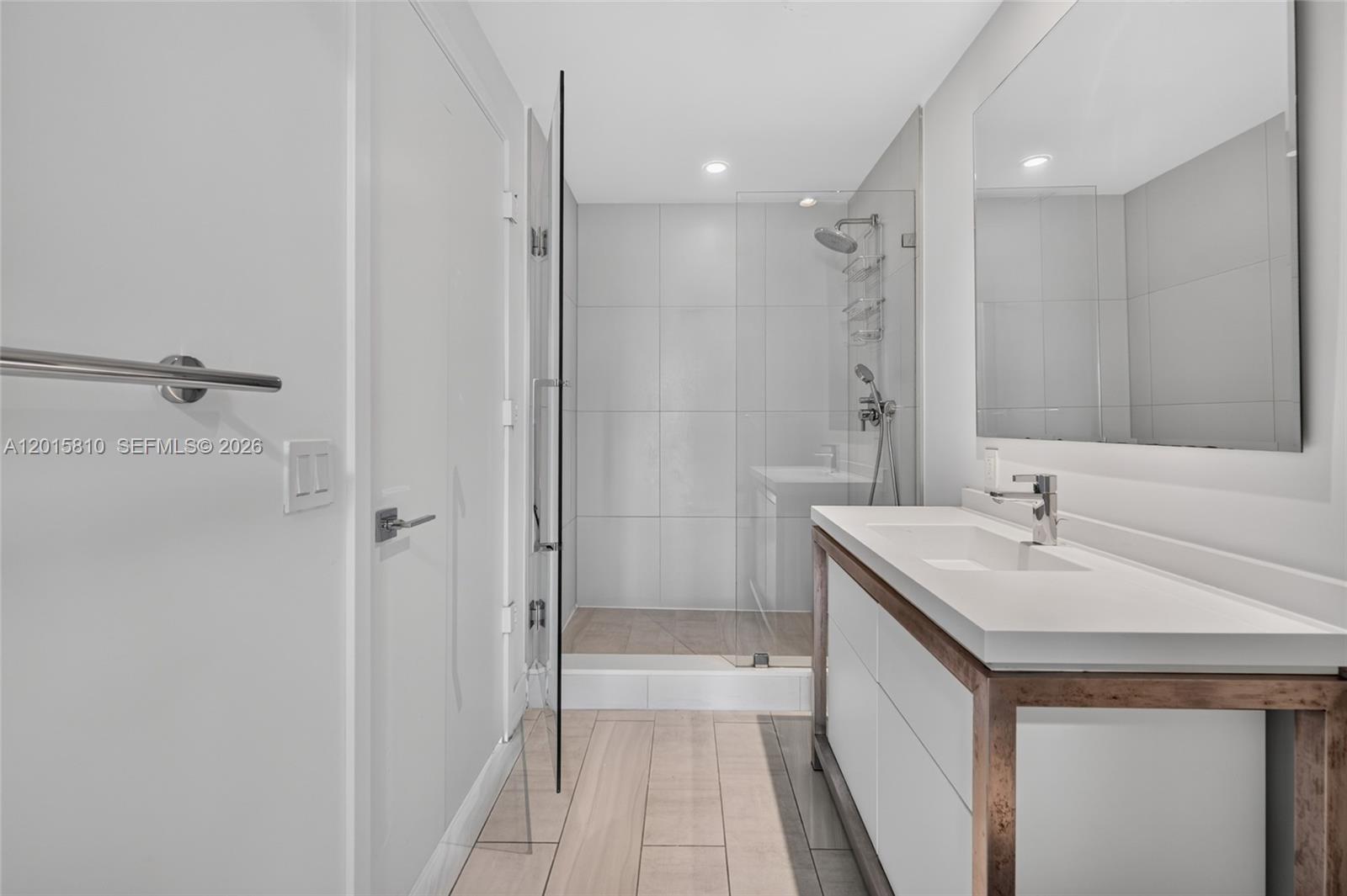 2000 Metropica Way, Unit 1902 Sunrise, FL 33323 - Photo 28 of 40 a bathroom with a sink a toilet and shower