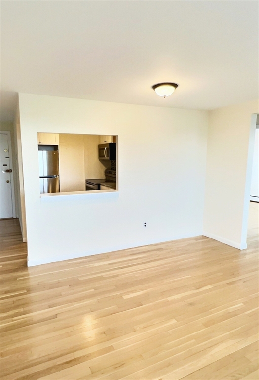 1039 Commonwealth Avenue, Unit 37 Boston, MA 02215 - Photo 4 of 7 a view of a room with wooden floor and cabinet