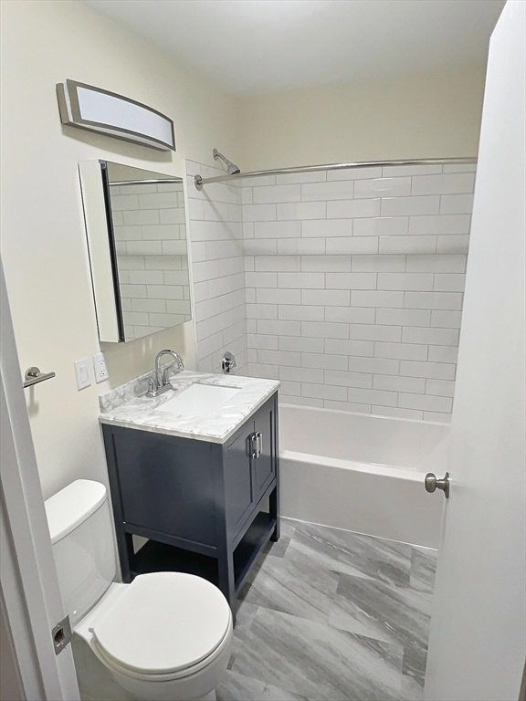 1039 Commonwealth Avenue, Unit 37 Boston, MA 02215 - Photo 7 of 7 a bathroom with a sink mirror vanity and toilet
