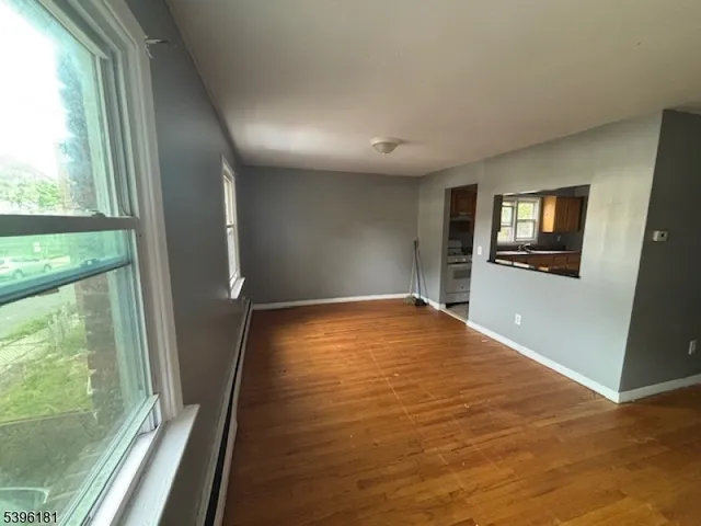 wooden floor in an empty room with a fireplace