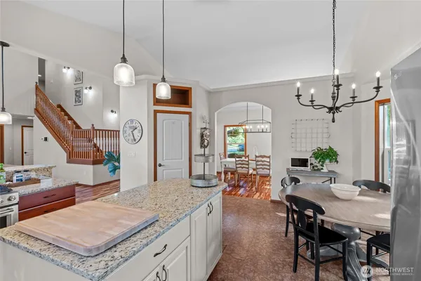 a living room with dining table and wooden floor