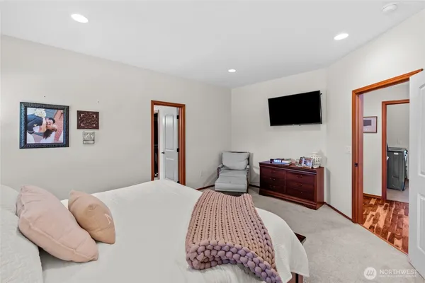 a bedroom with a bed and a flat screen tv