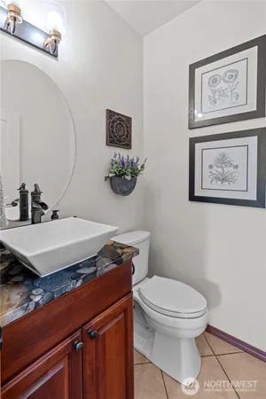 a bathroom with a toilet a sink and mirror