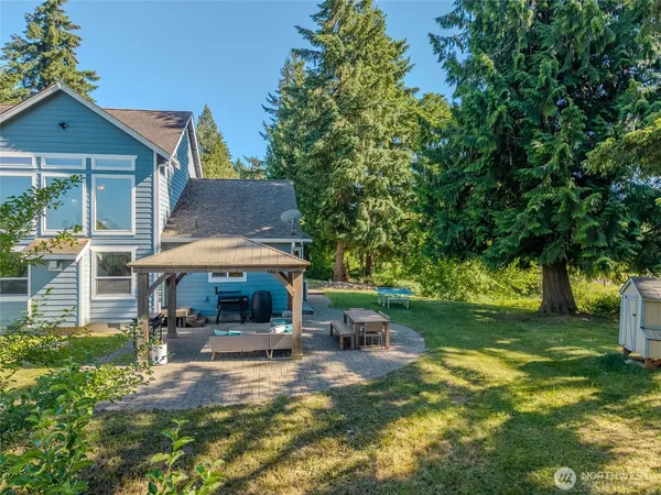 a view of a house with backyard and sitting area