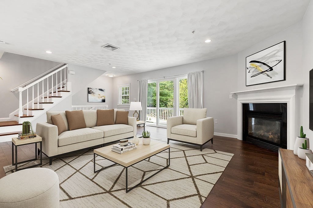 2 Ricciuti Drive, Unit 9 Quincy, MA 02169 - Photo 4 of 40 a living room with furniture and a fireplace