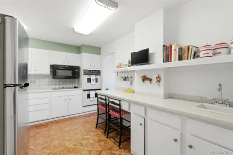 a kitchen with stainless steel appliances a sink and microwave