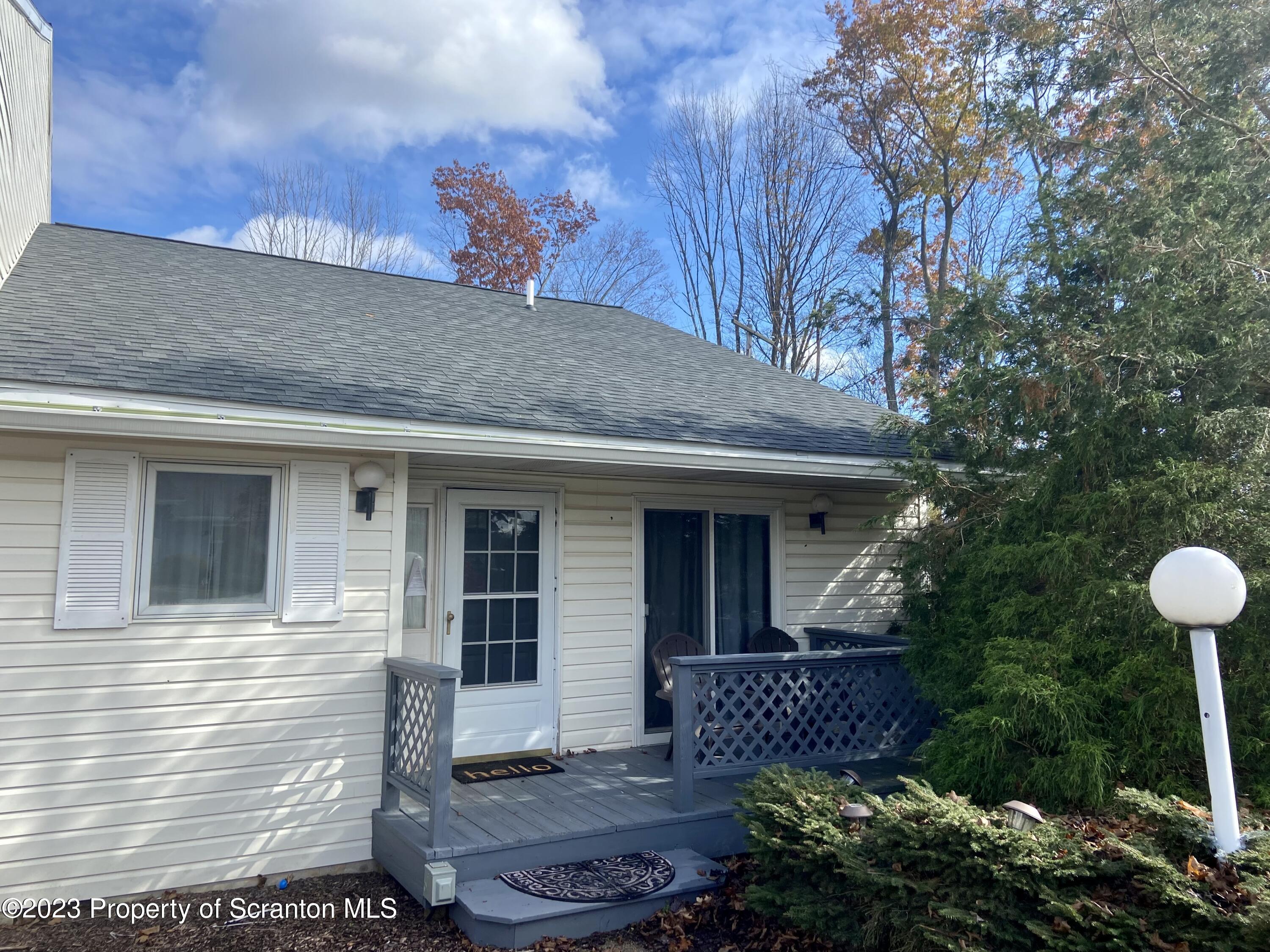 a front view of a house with plants