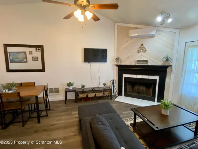 a living room with furniture a table and a fireplace